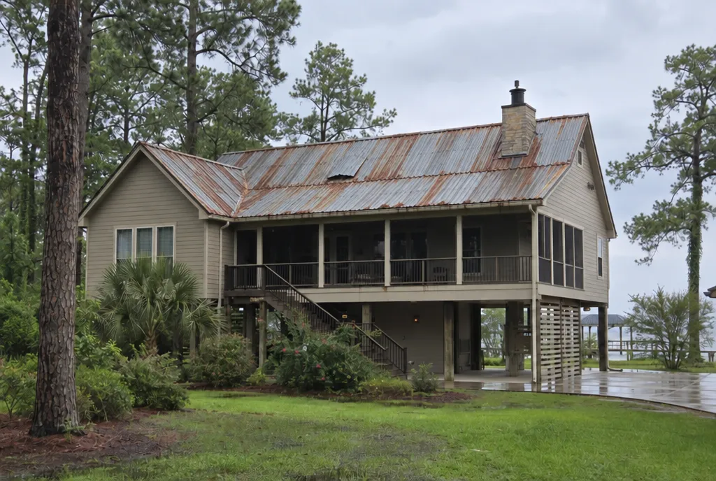 Sample image: a raised house with an old, rusted corrugated metal roof.