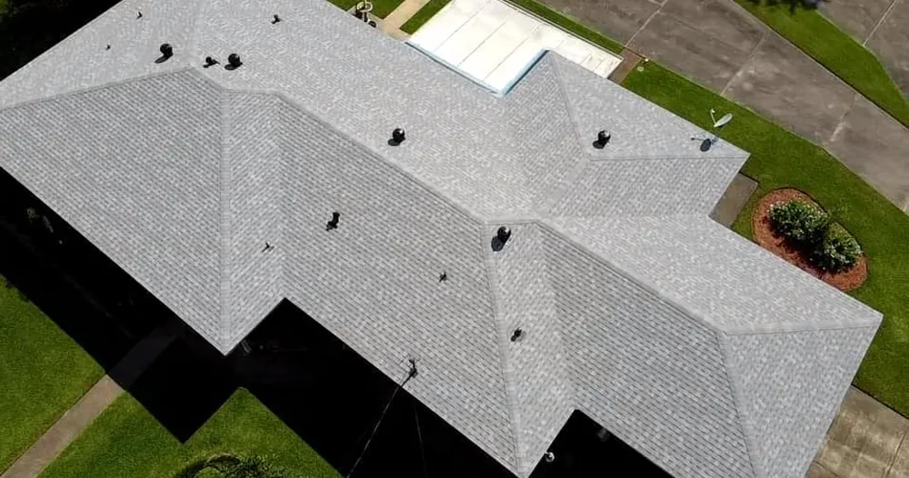 Drone view of a light grey hip roof on a single-storey house.